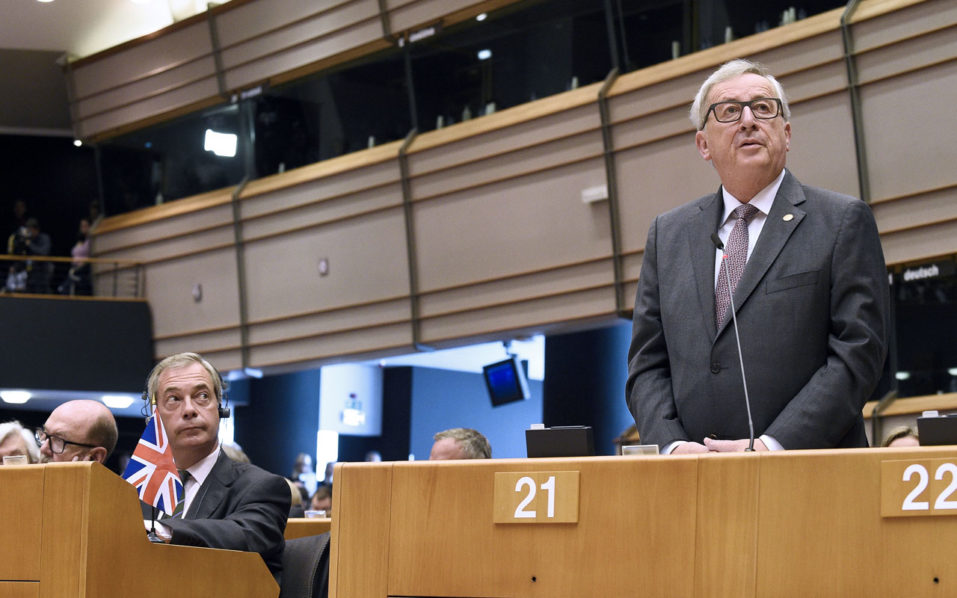 United Kingdom Independence Party leader Nigel Farage looks at European Union Commission President Jean Claude Juncker as he delivers a speech the European Union headquarters in Brussels