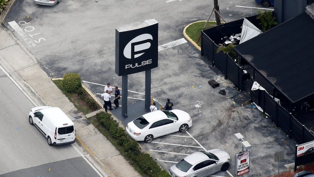 Investigators work the scene following a mass shooting at the Pulse gay nightclub in Orlando Florida