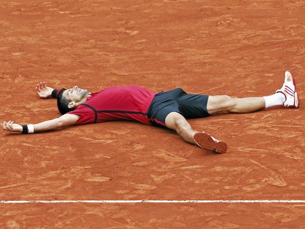 CLAY FEAT A relieved Novak Djokovic tries to take in his win in the French Open