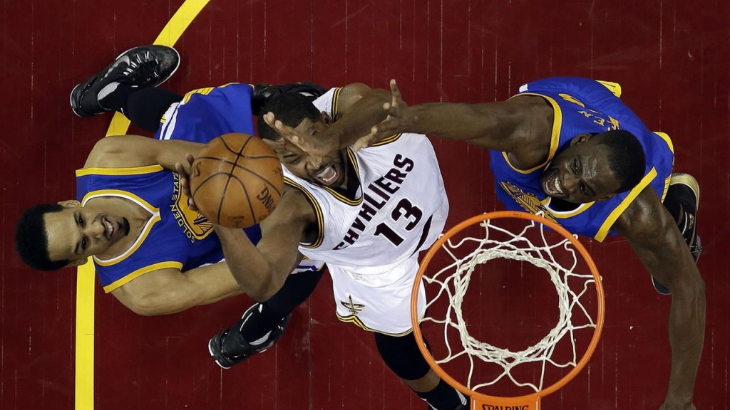 Golden State Warriors forward Harrison Barnes dunks on Cleveland Cavaliers guard Matthew Dellavedova during Game 3 of basketballs NBA Finals in Cleveland