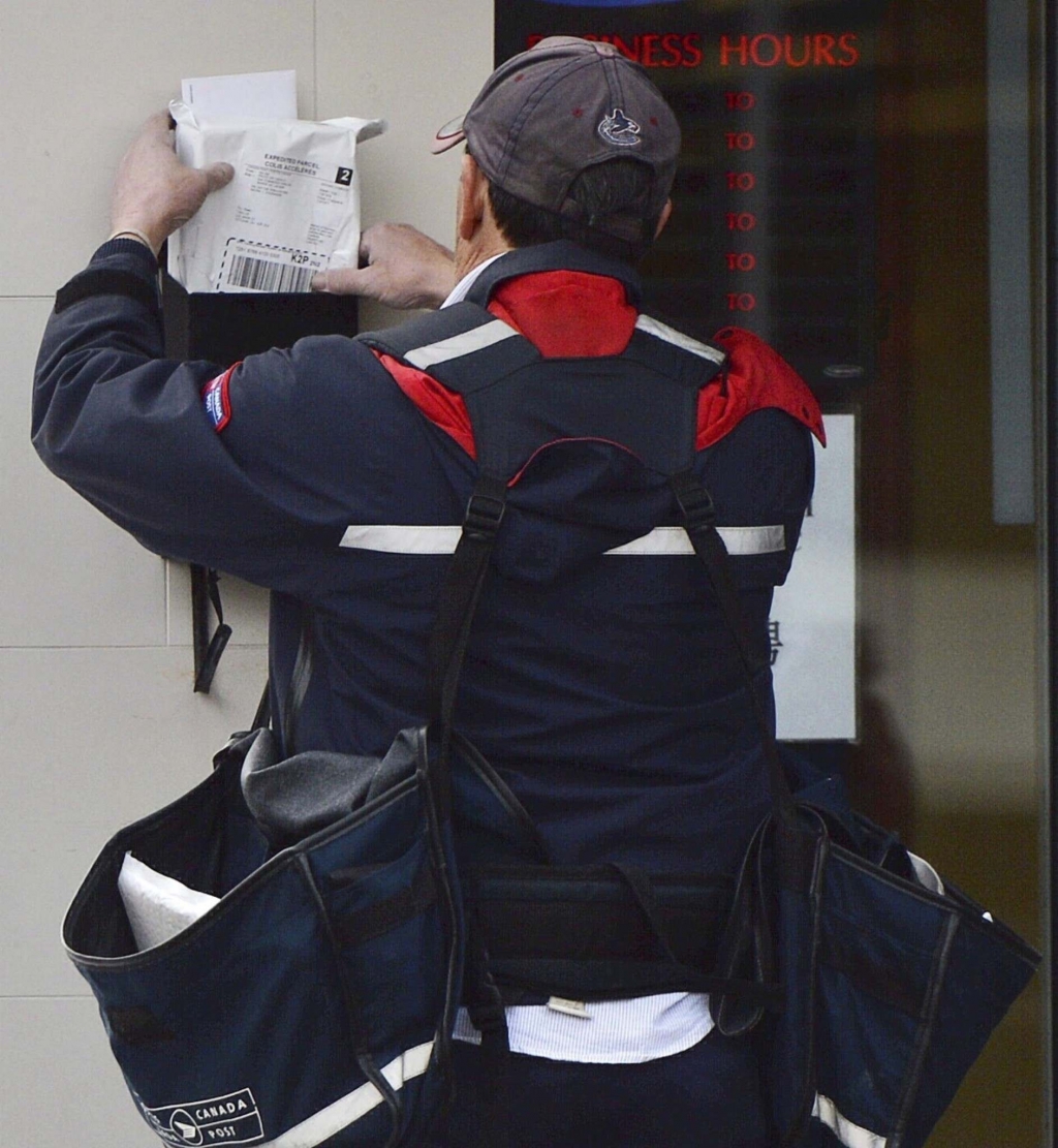 SEAN KILPATRICK  THE CANADIAN PRESS FILESA mail carrier delivers mail in Ottawa. Canada Post workers across Canada have voted more than 90 per cent in favour of a strike