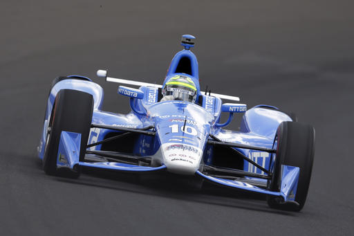 Tony Kanaan of Brazil drives the first turn during a practice session on the opening day of qualifications for the Indianapolis 500 auto race at Indianapolis Motor Speedway in Indianapolis Saturday