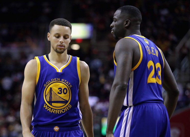 Stephen Curry #30 of the Golden State Warriors and Draymond Green #23 react during the second half against the Cleveland Cavaliers in Game 3 of the 2016 NBA Finals at Quicken Loans Arena