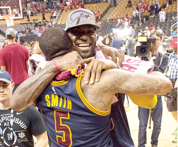 LeBron James hugs JR Smith after the Cleveland Cavaliers beat the Toronto Raptors 113-87 to advance to the NBA Finals for the second straight season