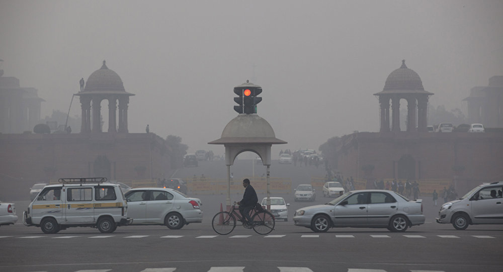 Vehicles move past the Presidential Palace as smog engulfs the evening in New Delhi India