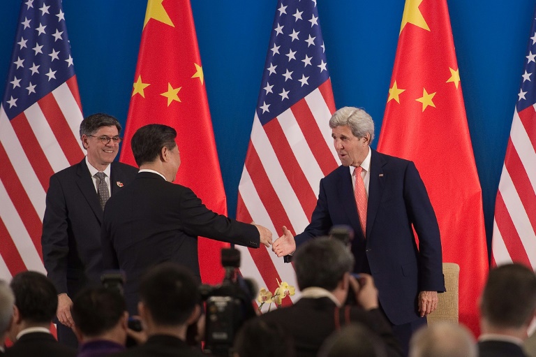 AFP  Nicolas AsfouriChina's President Xi Jinping shakes hands with US Secretary of State John Kerry as US Treasury Secretary Jacob Lew looks on during the opening session of the US- China Strategic and Economic Dialogues in Beijing on June 6