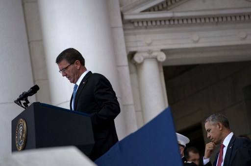 US President Barack Obama waits to speak as US Secretary of Defense Ashton Carter delivers remarks during a event to honor Memorial Day at Arlington National Cemetery