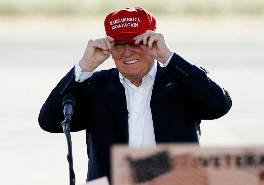 Republican presidential candidate Donald Trump wears his hat during a rally at the Sacramento International Jet Center in Sacramento Calif. Trump is suggesting that the Obama administration for political reasons plans to