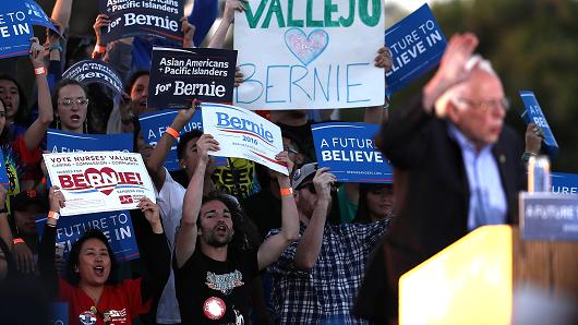 Supporters cheer as Democratic presidential candidate Sen. Bernie Sanders speaks at a campaign rally at Waterfront Park