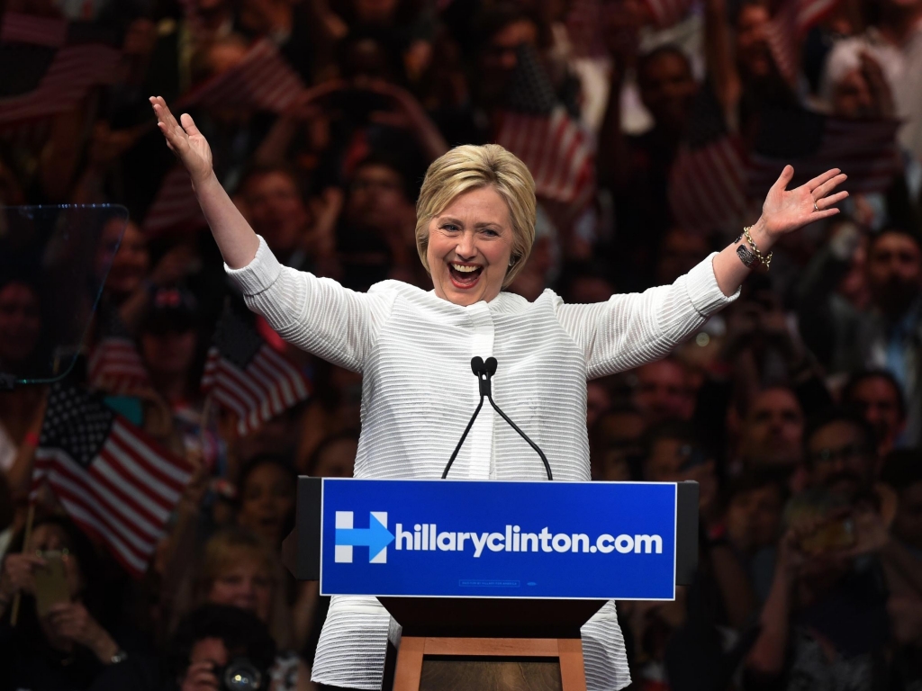 Hillary Clinton acknowledges celebratory cheers from the crowd during her primary night event at the Duggal Greenhouse Brooklyn Navy Yard in New York.'Thanks to you we've reached a milestone' she told cheering supporters at a rally in New York