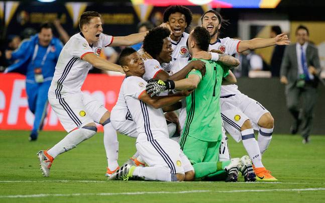 Colombia players celebrate after beating Peru on penalties