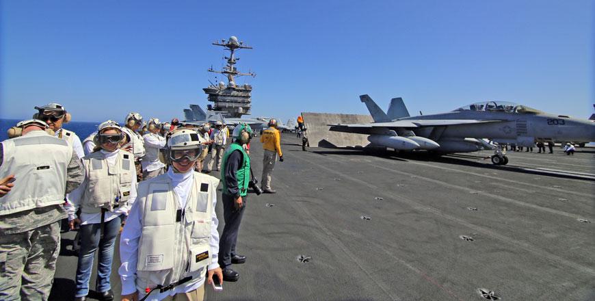 Crew members and officials are seen on board the USS Harry S. Truman aircraft carrier this week