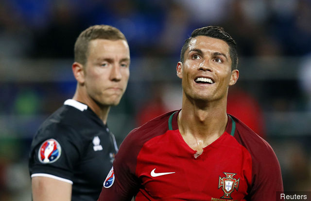 Portugal's Cristiano Ronaldo and Iceland's Hannes Halldorsson