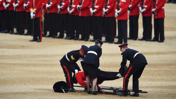 The guardsman was tended to and removed on a stretcher