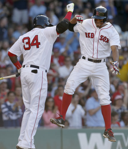 Boston’s Xander Bogaerts leaps to celebrate with on-deck batter David Ortiz after hitting a home run in the fifth inning against the Mariners at Fenway Park