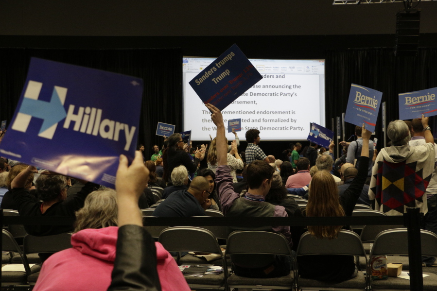 Democrats wave signs at the state Democratic convention in Tacoma on Saturday