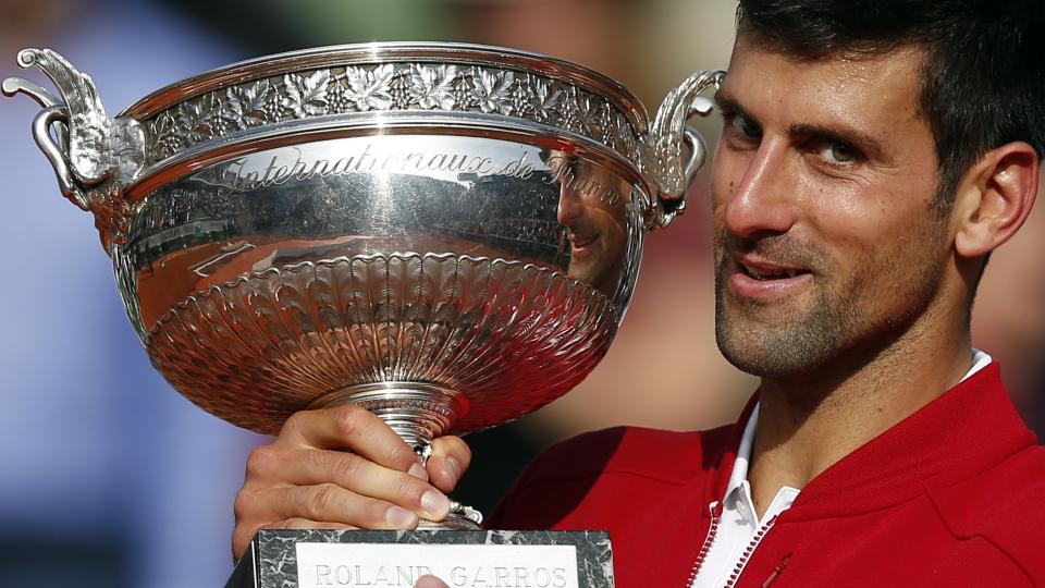 Serbia's Novak Djokovic holds the trophy after winning the final of the French Open tennis tournament against Britain's Andy Murray in four sets 3-6 6-1 6-2 6-4 at the Roland Garros stadium in Paris France. If