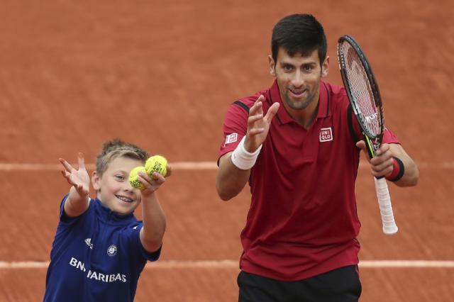 Djokovic celebrates his victory with a ball boy