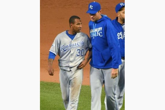 Kansas City Royals starting pitcher Yordano Ventura is walked off the field after drilling Baltimore Orioles batter Manny Machado sparking a brawl during the fifth inning of a baseball game Tuesday