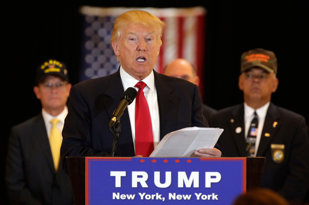 Republican presidential candidate Donald Trump reads from a list of donations to veteran's groups during a news conference in New York Tuesday