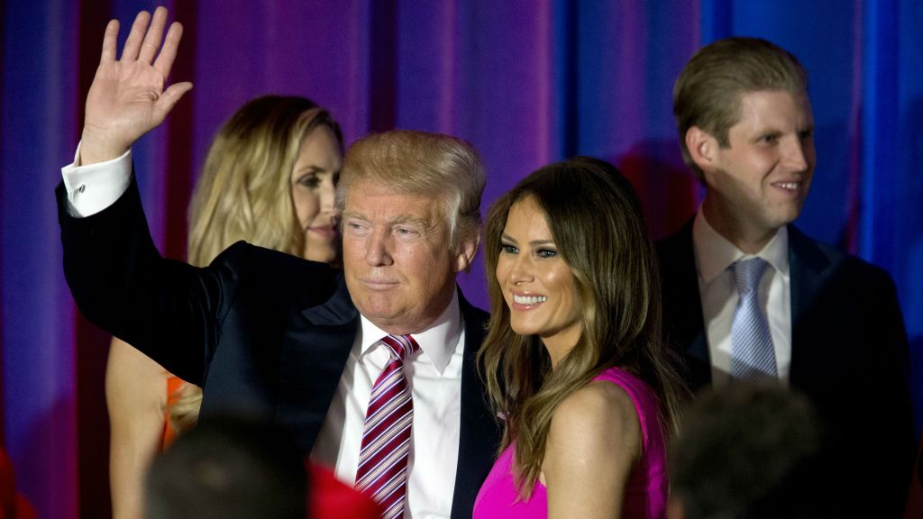 Republican presidential candidate Donald Trump waves at supporters as he leaves the stage with his wife Melania after a news conference at the Trump National Golf Club Westchester Tuesday