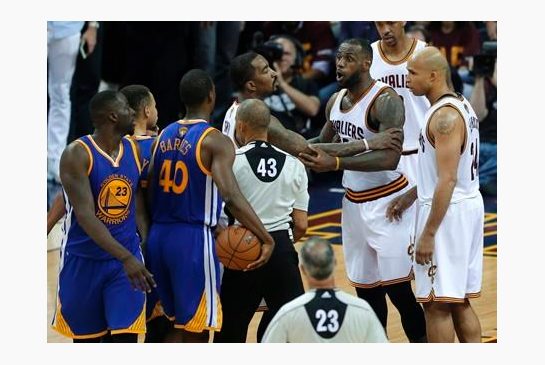 Cleveland Cavaliers forward Le Bron James is held back as he argues with Golden State Warriors forward Draymond Green during the second half of Game 4 of basketball's NBA Finals in Cleveland Friday