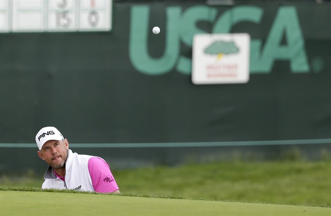 Lee Westwood of England hits out of the bunker on the seventh hole during the rain delayed first round of the U.S. Open golf championship at Oakmont Country Club on Friday