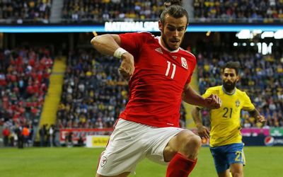 ELUSIVE Gareth Bale skips over Sweden’s Ludwig Augustinsson in a friendly at the weekend