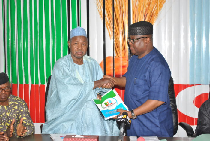 National Organising Secretary of the All Progressives Congress, Senator Osita Izunaso handing over relevant documents for the 2016 Edo State governorship election primaries to the Chairman of the Election Committee Katsina State Governor Am