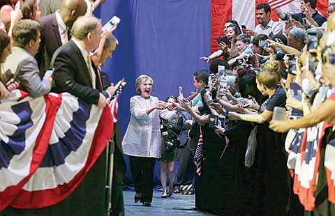 Democratic presidential candidate Hillary Clinton greets supporters as she arrives to speak during a presidential primary election night rally Tuesday