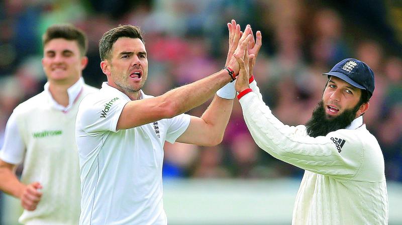 England’s James Anderson celebrates the wicket of Sri Lanka’s Kaushal Silva with teammate Moeen Ali on Day 3 of the first Test at Headingley England on Saturday