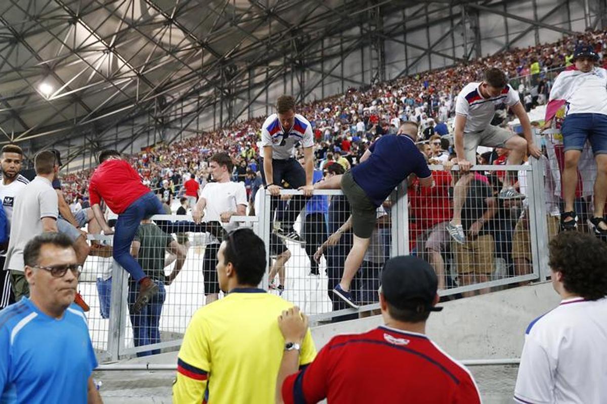 England fans flee from the stands after the game against Russia