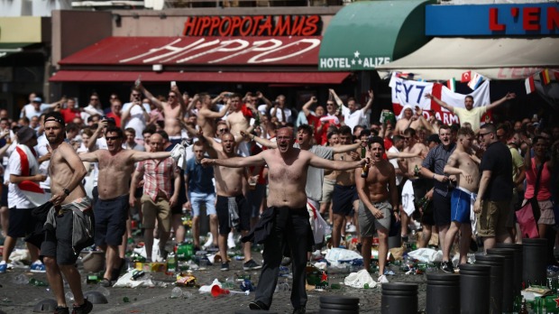 England fans gather cheer and clash with police ahead of the game against Russia