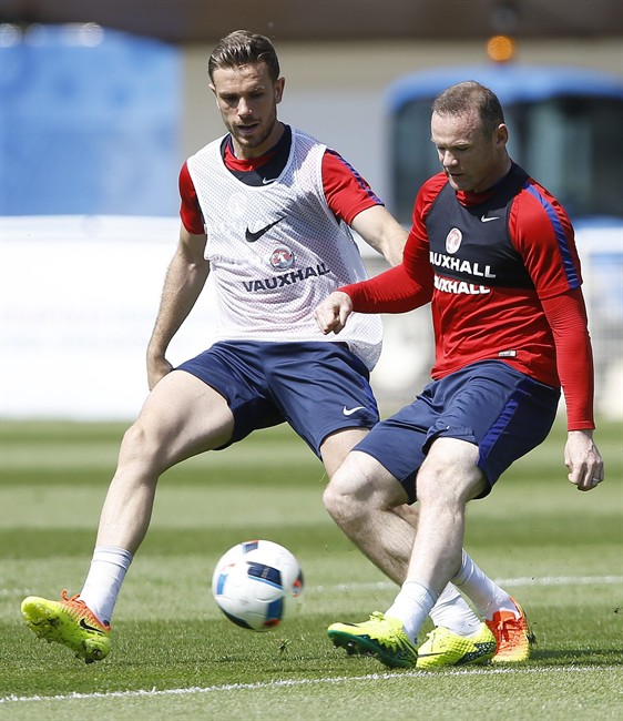 England’s Wayne Rooney right vies for the ball with England's Jordan Henderson during a training session in Chantilly France Thursday