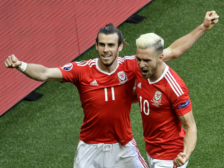 Gareth Bale left and Wales teammate Aaron Ramsey celebrate after an own goal by Northern Ireland defender Gareth Mc Auley during their Euro 2016 round of 16 match at the Parc des Princes stadium in Paris on Saturday