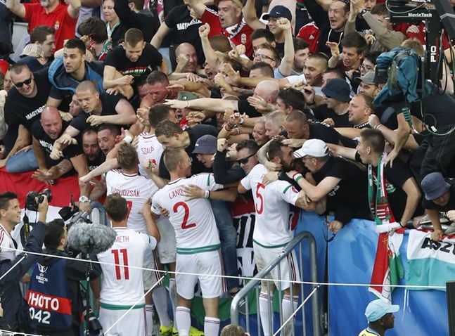 Hungary's players celebrate with fans after team mate Adam Szalai scored a goal during the Euro 2016 Group F soccer match between Austria and Hungary at the Nouveau Stade in Bordeaux France Tuesday