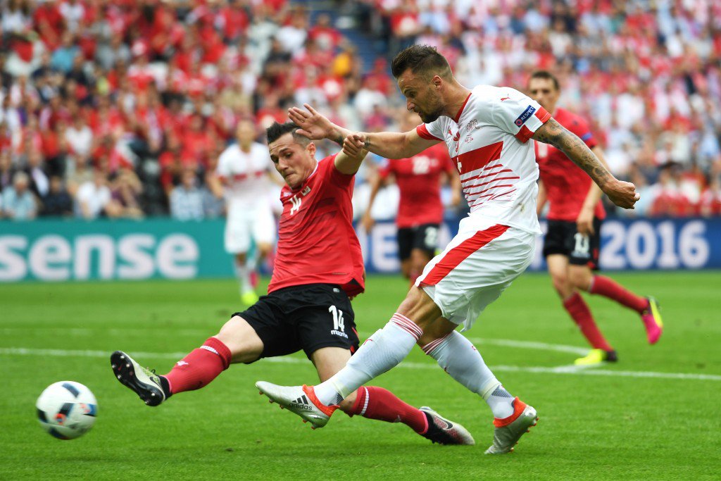 LENS FRANCE- JUNE 11 Haris Seferovic of Switzerland shoots at goal while Taulant Xhaka of Albania tries to block during the UEFA EURO 2016 Group A match between Albania and Switzerland at Stade Bollaert Delelis