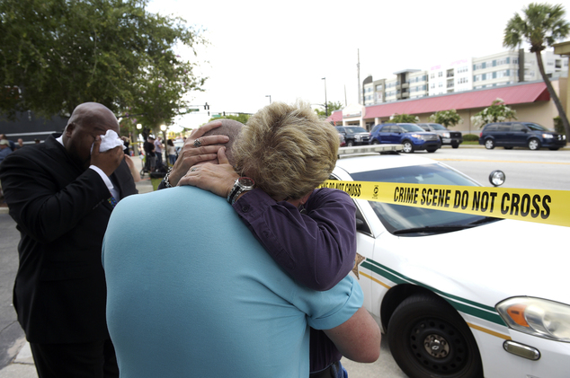 Terry DeCarlo executive director of the LGBT Center of Central Florida center is comforted by Orlando City Commissioner Patty Sheehan right after a shoo