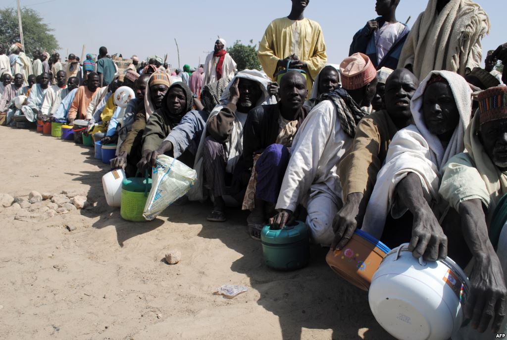 FILE- Internally displaced persons wait to be served with food at Dikwa camp in northeast Nigeria's Borno state Feb. 2 2016