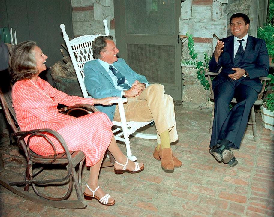 Billy and his wife Ruth Graham share a laugh with the late boxing legend Muhammad Ali in this undated