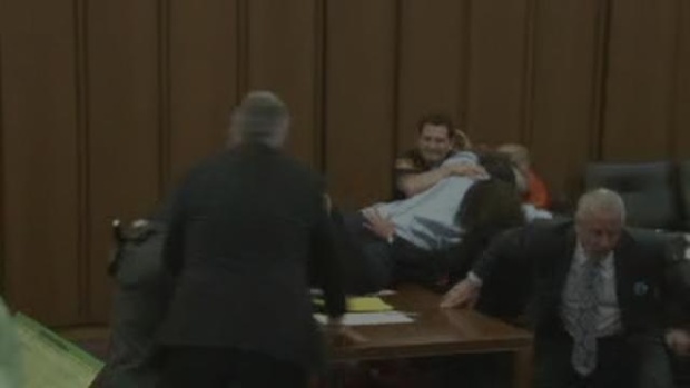 Father of victim leaps across table to grab serial killer's throat during sentencing hearing