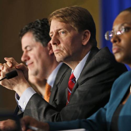 Consumer Financial Protection Bureau Director Richard Cordray center listens to comments during a panel discussion in Richmond Va. The CFPB announced Thursday