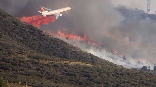 Fire burns through the hills on the south side of Yarnell on Wednesday afternoon