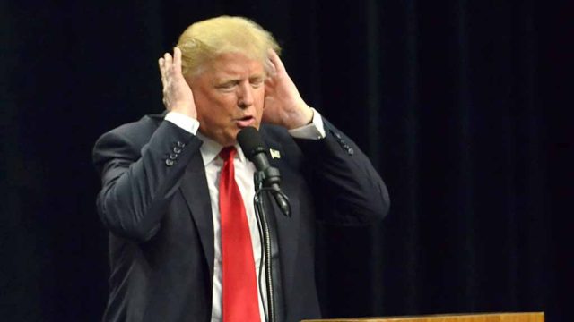 Donald Trump shows his reaction to the sound of Democratic Presidential Candidate Hillary Clinton's voice