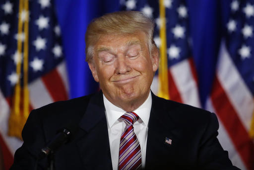 Republican presidential candidate Donald Trump pauses as he speaks at the Trump National Golf Club Westchester New York