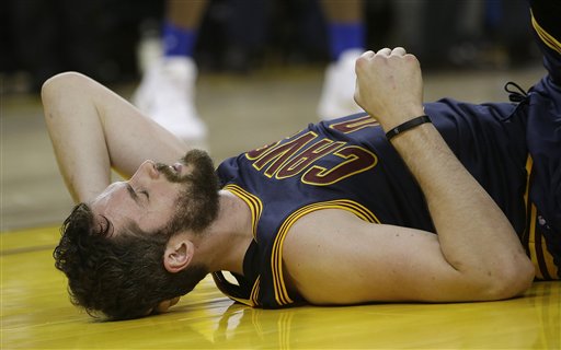 Cleveland Cavaliers forward Kevin Love remains on the floor after a play during the first half of Game 2 of basketball's NBA Finals between the Golden State Warriors and the Cavaliers in Oakland Calif. Sunday