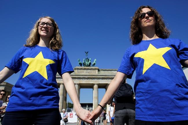 Members of the youth organizations of Germany's Social Democratic Party and the Green Party attend a event to support the European Union in front of the Brandenburg Gate in Berlin Friday