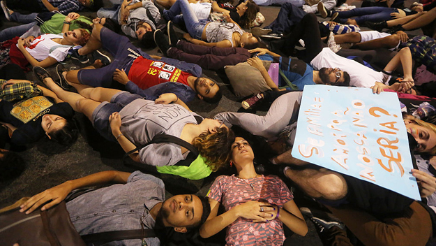 Pro-LGBT activists in Brazil lie on the street during a march honoring victims of the mass shooting at a gay nightclub in Orlando Florida