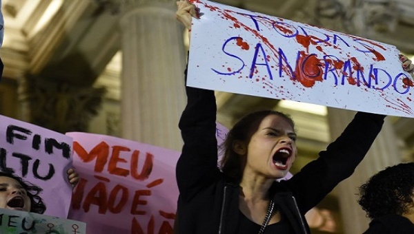 Brazilians protest in front of the Legislative Assembly of Rio de Janeiro on Friday against an alleged gang rape that police say they are investigating