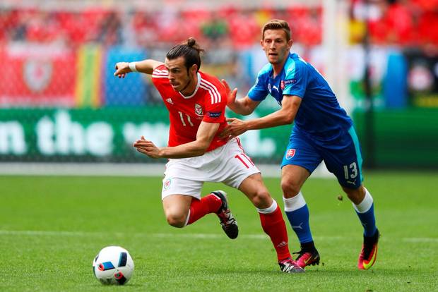 Gareth Bale of Wales and Patrik Hrosovsky of Slovakia compete for the ball during the UEFA EURO 2016 Group B match between Wales and Slovakia at Stade Matmut Atlantique